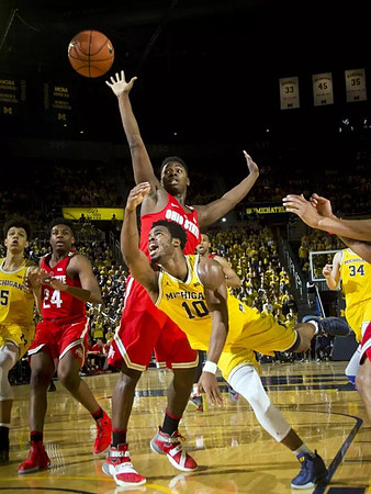 D.J. Wilson (5), Derrick Walton Jr. (10), and Mark Donnal (34)