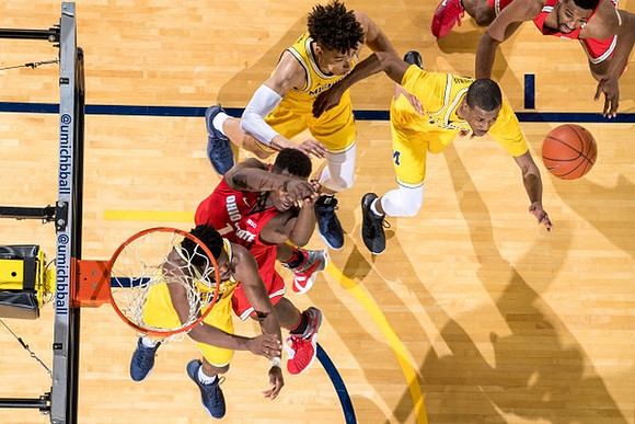 Derrick Walton Jr. (10), D.J. Wilson (5), and Muhammad-Ali Abdur-Rahkman (12)