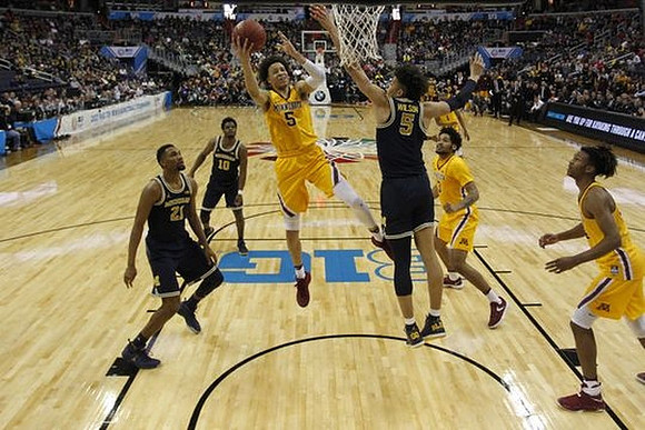 Zak Irvin (21), Derrick Walton Jr. (10), and D.J. Wilson (5)