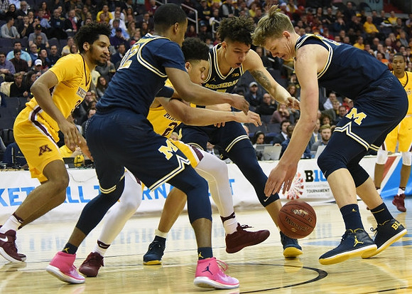 Muhammad-Ali Abdur-Rahkman (12), D.J. Wilson (5), and Moritz Wagner (13)