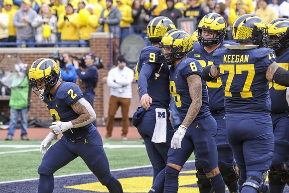 Blake Corum (2), J.J. McCarthy (9), Ronnie Bell (8), Trevor Keegan (77), and Zak Zinter (65)