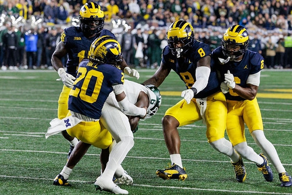 Ernest Hausmann (15), Jyaire Hill (20), Derrick Moore (8), and Brandyn Hillman (6)