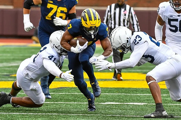 Ryan Hayes (76) and Donovan Edwards (7)