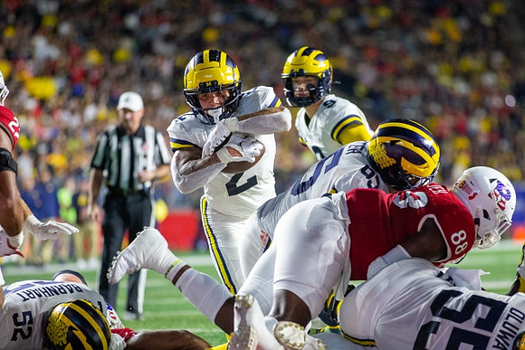 Karsen Barnhart (52), Blake Corum (2), J.J. McCarthy (9), Zak Zinter (65), and Olusegun Oluwatimi (55)