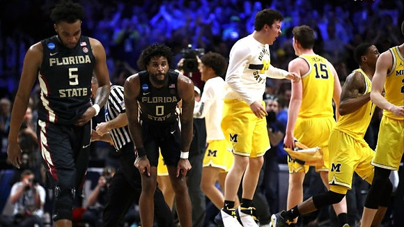 C.J. Baird (24), Jon Teske (15), Charles Matthews (1), and Michigan Team