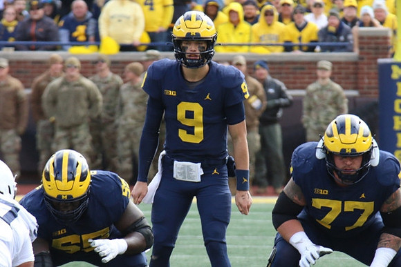 Olusegun Oluwatimi (55), J.J. McCarthy (9), and Trevor Keegan (77)