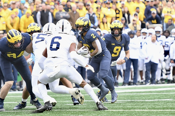 Joel Honigford (84), Blake Corum (2), and J.J. McCarthy (9)