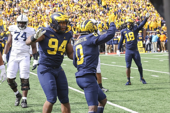 Kris Jenkins (94), Mike Sainristil (0), and Eyabi Anoma Okie (18)