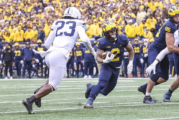 Blake Corum (2) and Luke Schoonmaker (86)