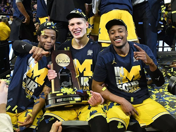 Zavier Simpson (3), Moritz Wagner (13), Muhammad-Ali Abdur-Rahkman (12), and West Regional Championship Trophy