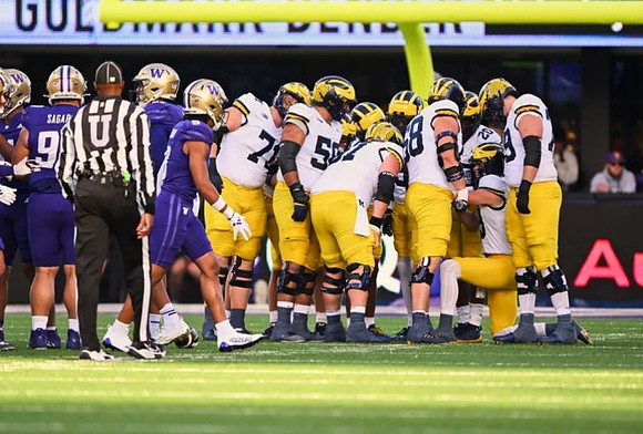 Jack Tuttle (13) and Michigan Team