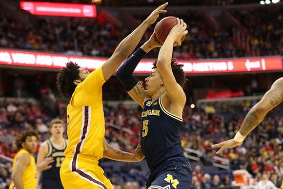 D.J. Wilson (5) and Moritz Wagner (13)