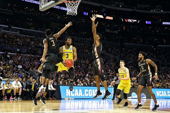 Zavier Simpson (3) and Moritz Wagner (13)