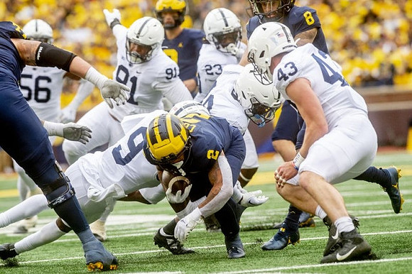 Trevor Keegan (77), Blake Corum (2), J.J. McCarthy (9), and Ronnie Bell (8)