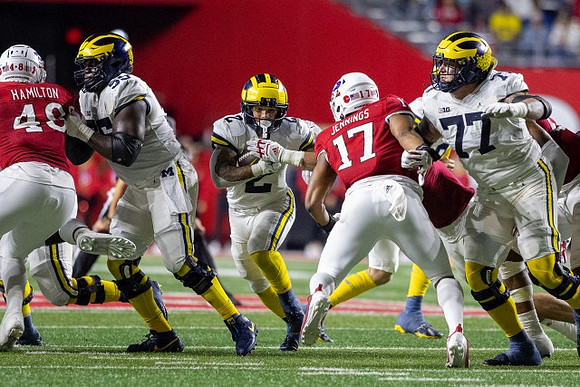 Olusegun Oluwatimi (55), Blake Corum (2), and Trevor Keegan (77)