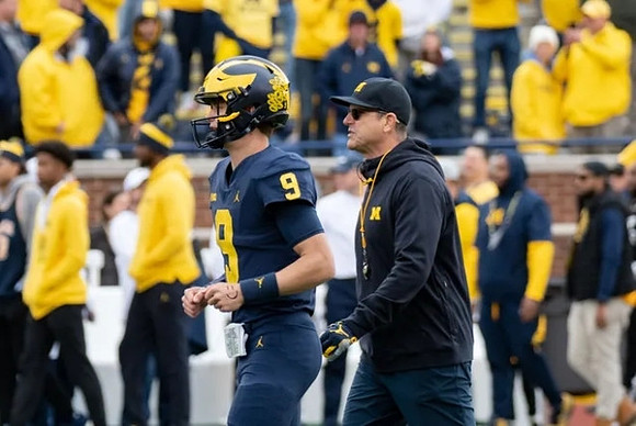 J.J. McCarthy (9) and Jim Harbaugh