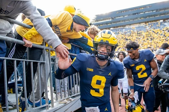 J.J. McCarthy (9) and Will Johnson (2)
