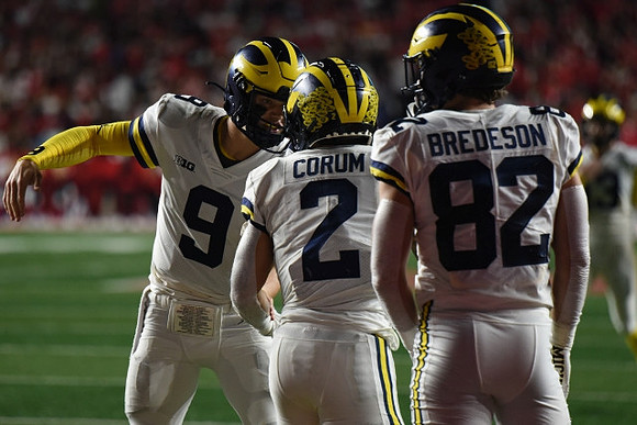 J.J. McCarthy (9), Blake Corum (2), and Max Bredeson (82)