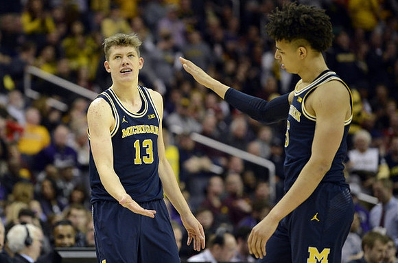 Moritz Wagner (13) and D.J. Wilson (5)