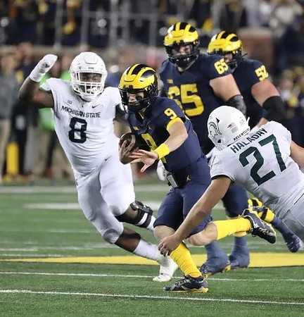 J.J. McCarthy (9), Zak Zinter (65), and Karsen Barnhart (52)