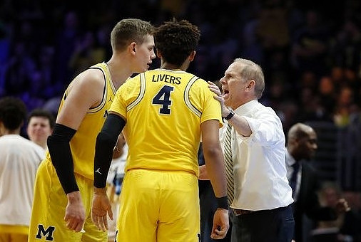 Moritz Wagner (13), Isaiah Livers (4), and John Beilein
