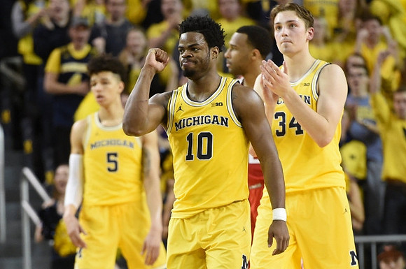 D.J. Wilson (5), Derrick Walton Jr. (10), and Mark Donnal (34)