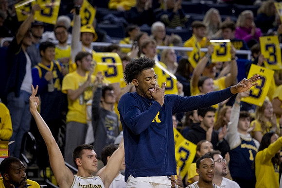 Jace Howard (7) and Michigan Team