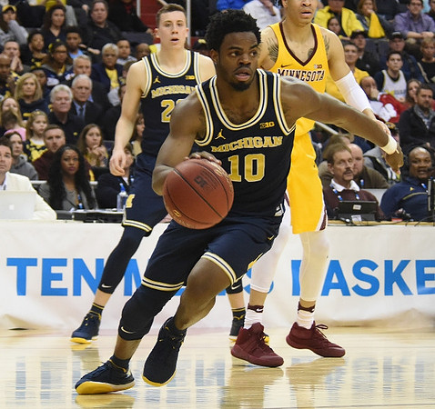 Duncan Robinson (22) and Derrick Walton Jr. (10)