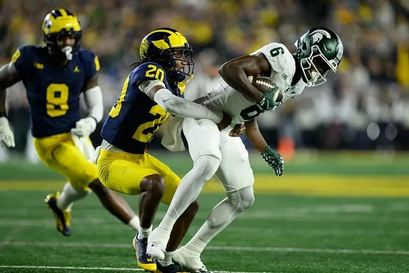 Derrick Moore (8) and Jyaire Hill (20)