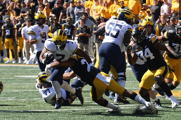 Trevor Keegan (77), J.J. McCarthy (9), Donovan Edwards (7), and Olusegun Oluwatimi (55)