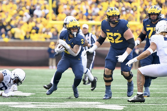 Blake Corum (2), Karsen Barnhart (52), and Trevor Keegan (77)