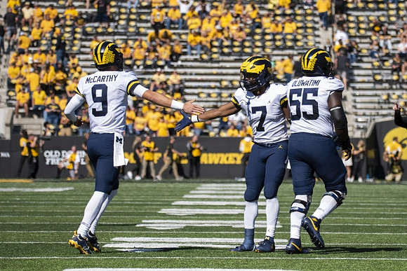 J.J. McCarthy (9), Donovan Edwards (7), and Olusegun Oluwatimi (55)
