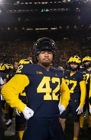 TJ Guy (42) and Michigan Team