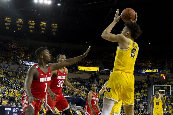 D.J. Wilson (5) and Derrick Walton Jr. (10)