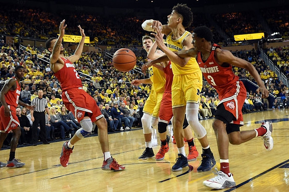D.J. Wilson (5) and Moritz Wagner (13)