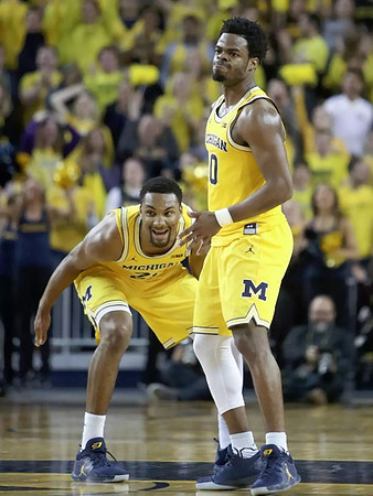 Zak Irvin (21) and Derrick Walton Jr. (10)