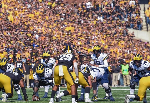 Zak Zinter (65), Olusegun Oluwatimi (55), J.J. McCarthy (9), Trevor Keegan (77), Blake Corum (2), and Ryan Hayes (76)