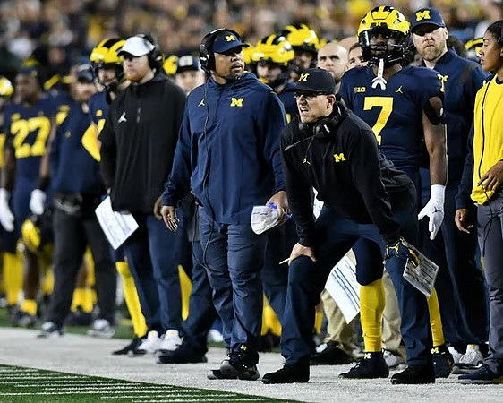 Jay Harbaugh, Mike Hart, Jim Harbaugh, Donovan Edwards (7), and Michigan Team