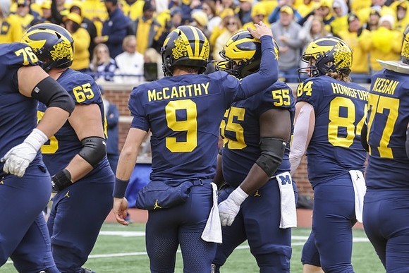 Ryan Hayes (76), Zak Zinter (65), J.J. McCarthy (9), Olusegun Oluwatimi (55), Joel Honigford (84), and Trevor Keegan (77)