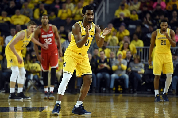 Moritz Wagner (13), Derrick Walton Jr. (10), and Zak Irvin (21)