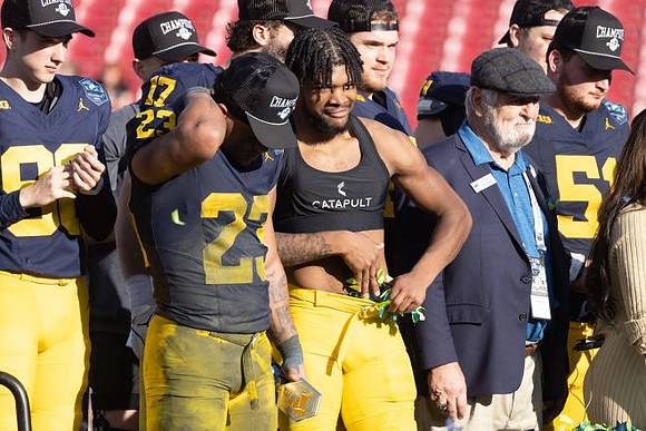 Jordan Marshall (23) and Michigan Team