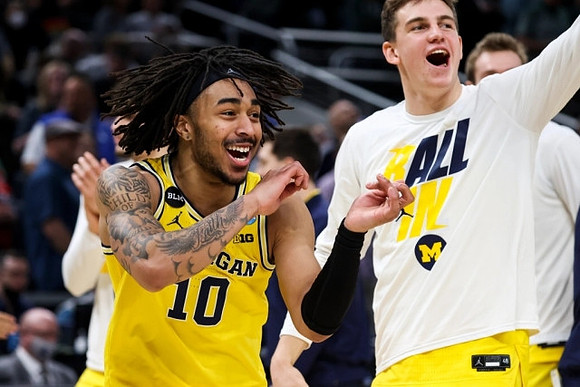 Frankie Collins (10) and Michigan Team