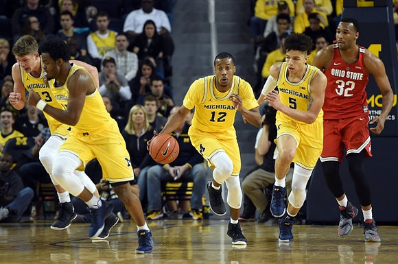 Moritz Wagner (13), Derrick Walton Jr. (10), Muhammad-Ali Abdur-Rahkman (12), and D.J. Wilson (5)