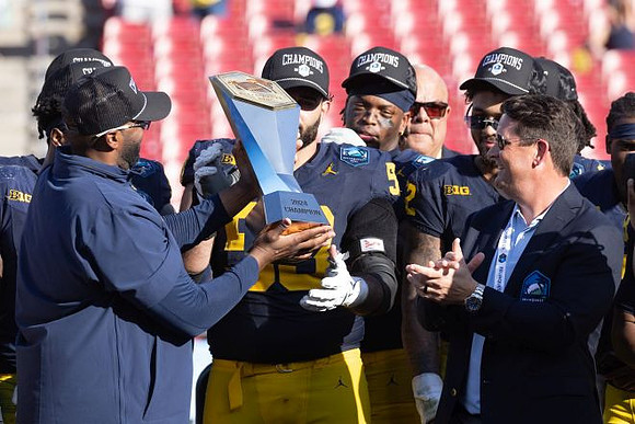 Sherrone Moore, Michigan Team, and ReliaQuest Bowl Trophy