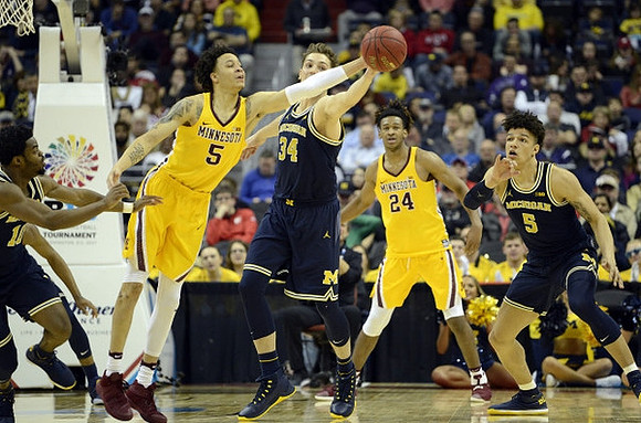 Derrick Walton Jr. (10), Mark Donnal (34), and D.J. Wilson (5)