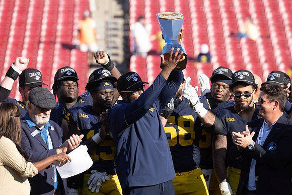 Sherrone Moore, Michigan Team, and ReliaQuest Bowl Trophy