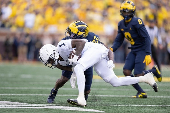 Gemon Green (22) and Mike Sainristil (0)