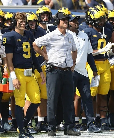 J.J. McCarthy (9), Jim Harbaugh, and Darrius Clemons (0)