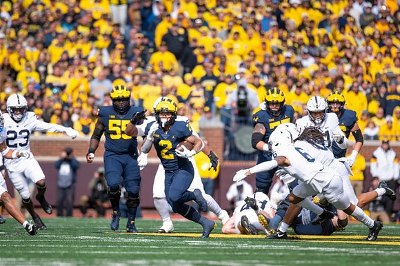 Olusegun Oluwatimi (55), Blake Corum (2), and Trevor Keegan (77)
