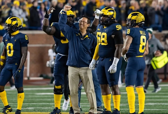 Mike Sainristil (0), Olusegun Oluwatimi (55), Mazi Smith (58), and Ronnie Bell (8)